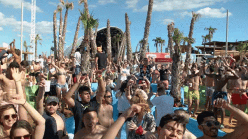 Crowd Of People At Beach Party With Coca-Cola Sign GIF