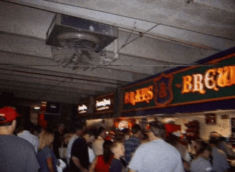 Crowd of People Under Brau's Brewery Sign
