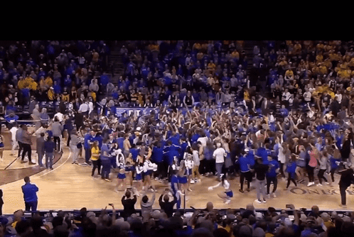 Crowd on Basketball Court With TCU Banner