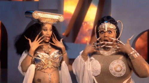 Crowned Woman With Long Nails Next to Woman