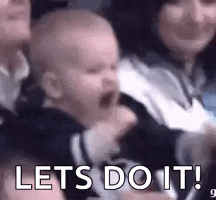 Crying Baby in Crowd Held by Woman