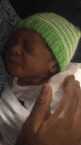 Crying Baby in Green Hat