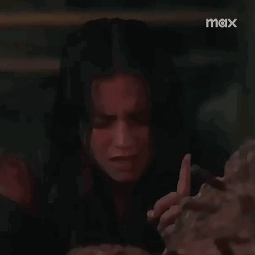 Crying Woman Holding Bricks in Dark Room