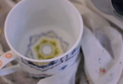 Cup Of Hot Chocolate Poured Into Napkin GIF