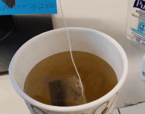 Cup Of Tea With Tea Bag And Pure Aqua Bottle GIF
