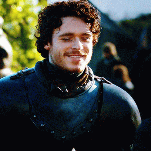 Curly Bearded Man In Armor And Scarf GIF