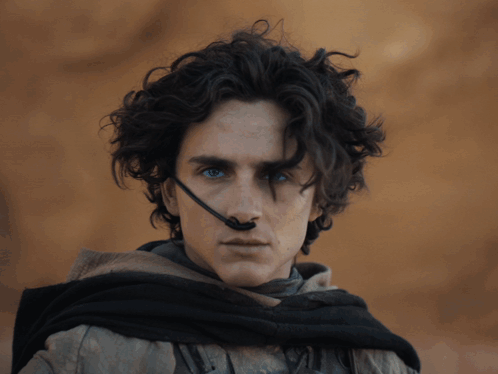 Curly Hair Blue Eyes Man Headset on Nose