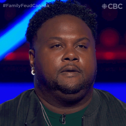 Curly Haired Bearded Man With CBC Logo