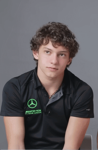 Curly Haired Man in Black AMG Shirt