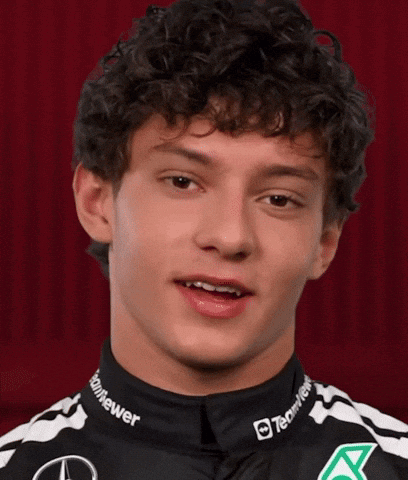 Curly Haired Man in Black and White Shirt Says Some Nice
