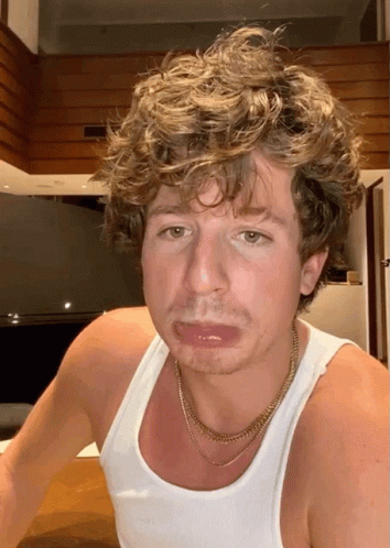 Curly Haired Man in White Tank Top With Gold Chain