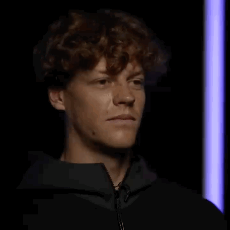 Curly-Haired Man Making Funny Face In Dark Room GIF