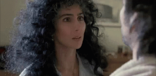 Curly-Haired Woman Looking at Another Woman
