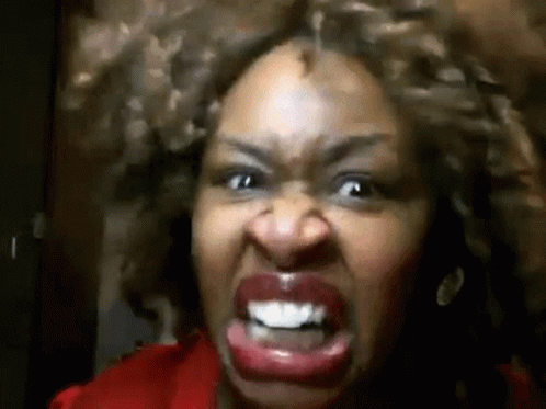 Curly-Haired Woman Making Angry Face GIF