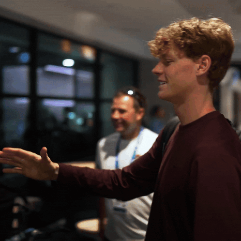 Curly Haired Young Man In Dark Room GIF
