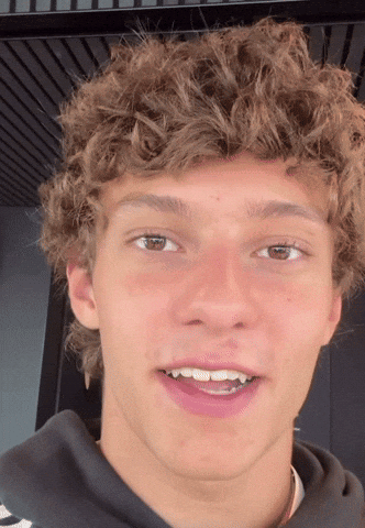 Curly Haired Young Man Staring Open Mouthed