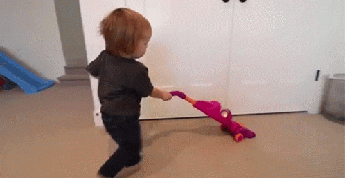 Cute Baby Using Toy Vacuum GIF