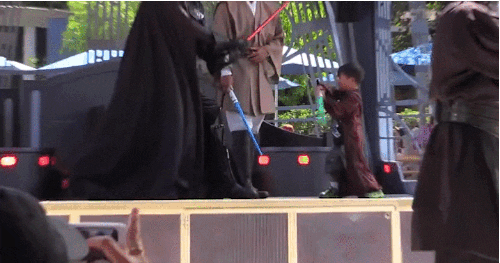 Cute Boy As Light Saber Jedi In Disneyland GIF