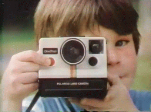 Cute Kid Taking Polaroid Pictures GIF