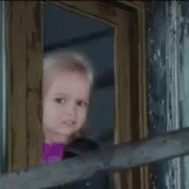 Cute Young Girl Looking Out The Window GIF