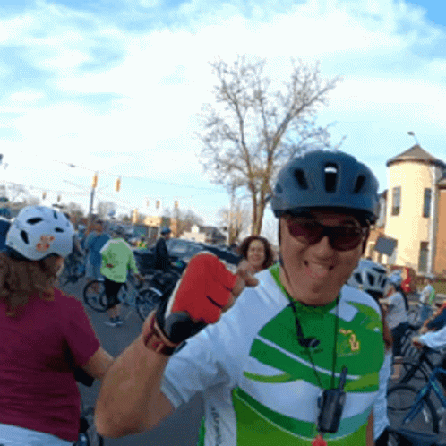 Cyclist Fist Bump With Tongue Out GIF