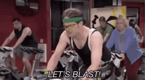 Cyclists On Track With Smiley Face On Head GIF
