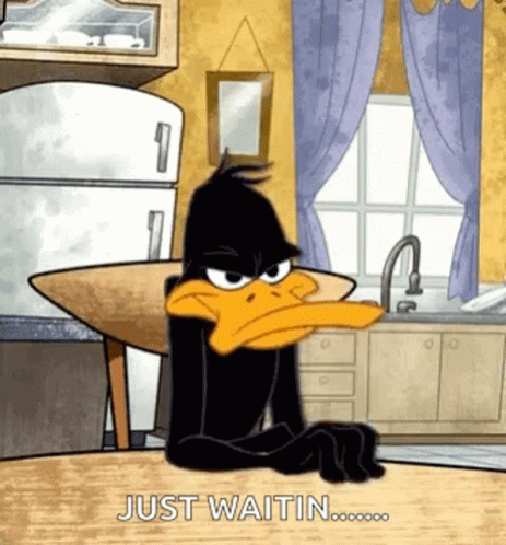 Daffy Duck Sitting At Table Waiting GIF