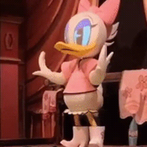 Daisy Duck Is Wearing A Pink Dress And White Boots While Dancing On A Stage . GIF