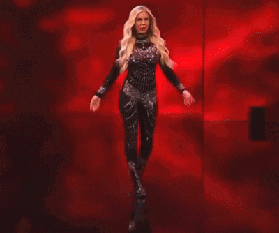 Dana Brooke Is Standing In Front Of A Red Banner That Says Raw GIF