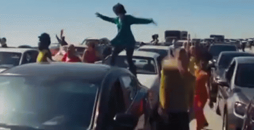 Dancing On Top Of Cars In Traffic GIF
