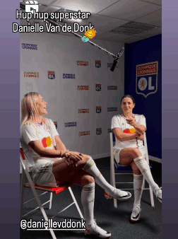 Danielle Van De Donk Sits In A Chair With A Microphone In Front Of A Wall That Says Olympique Lyonnais GIF