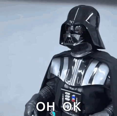 Darth Vader From Star Wars Is Wearing A Helmet And Cape And Holding A Light Saber . GIF