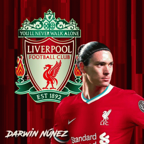 Darwin Nunez Stands In Front Of A Liverpool Football Club Poster GIF