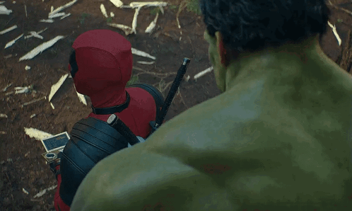 Deadpool And The Hulk Are Standing Next To Each Other In A Forest . GIF
