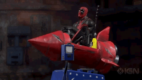 Deadpool Is Riding A Red Rocket With Ign Written On The Bottom GIF