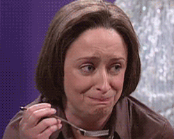 Debbie Downer Eating & Smirking GIF