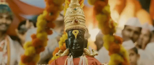 Deity Statue With Yellow Eye And Gold Hat GIF