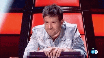 Denim Jacket Man Hands Folded on Red Chair