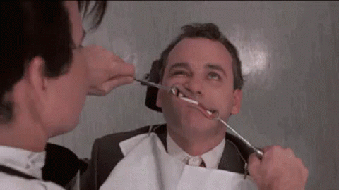 Dentist Examining Man's Teeth GIF