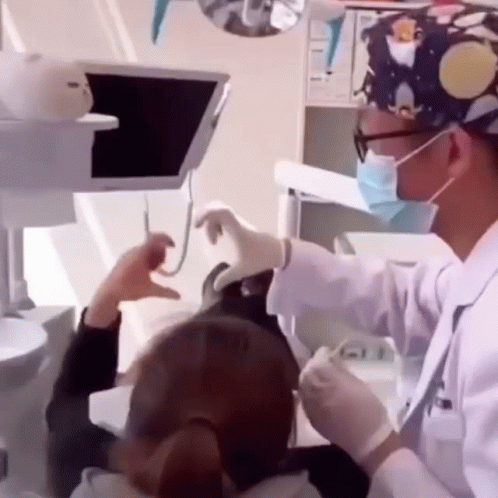 Dentist Examining Woman's Teeth