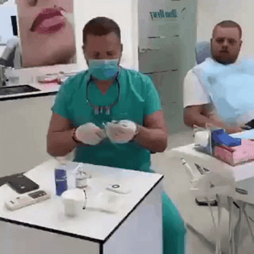 Dentist Preparing to Treat Patient With Mask and Gloves