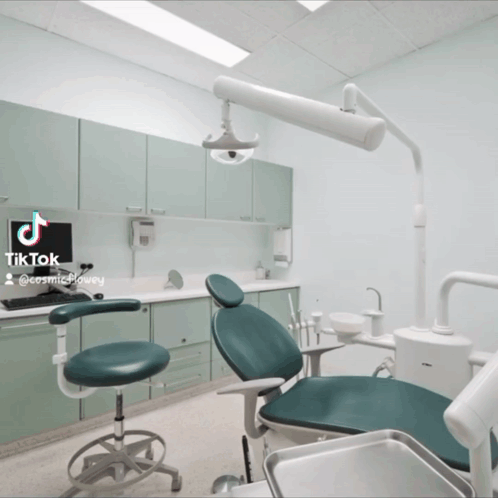 Dentist's Office With Green Chair And Computer On Counter GIF