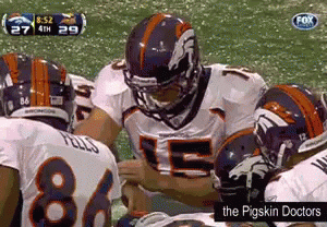 Denver Broncos Players Huddling