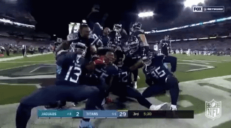 Derrick Henry Stiff Arm Posing With Team GIF