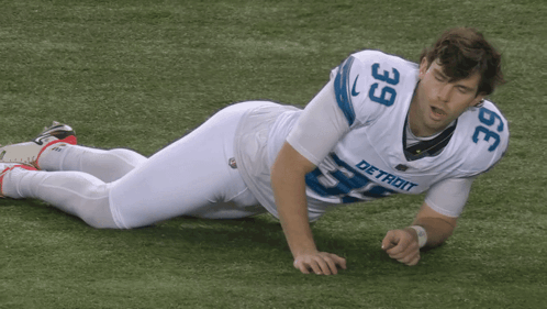 Detroit Football Player Laying On Ground GIF