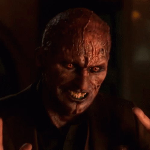 Devil Face Close Up With Hand Reaching Out