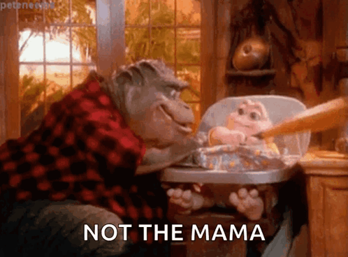 Dinosaur Feeding Baby In High Chair Saying Not The Mama GIF