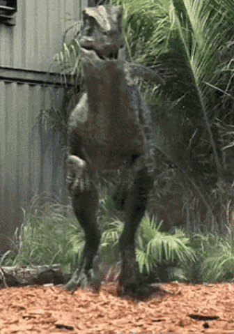 Dinosaur Statue In Front Of Building GIF