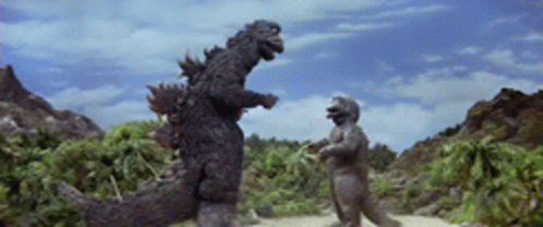 Dinosaur Statue Standing Next To Another GIF
