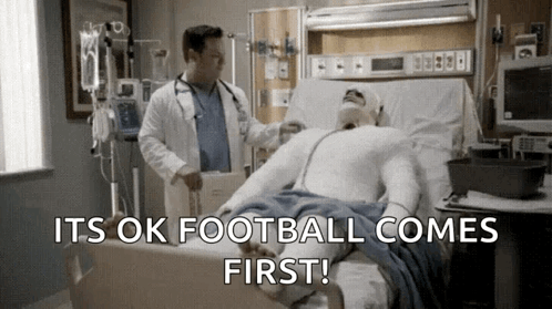 Doctor Examining Man in Hospital Bed Football Comes First